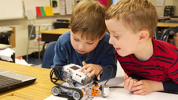 Dos estudiantes colaborando en un robot